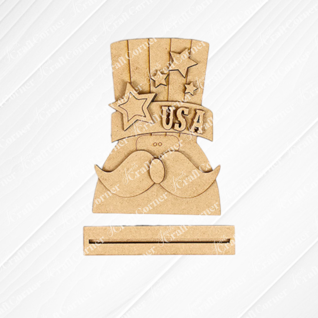 Janet's Craft Corner Patriotic Mini Shelf Sitters – DIY Craft Kit features a mustache and Uncle Sam hat with stars and "USA," plus a slot below for signs or cards—ideal for Americana décor or personalized wood crafts.