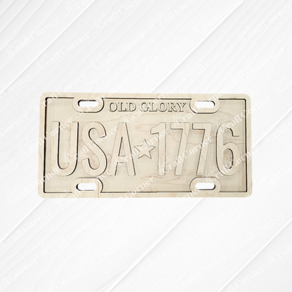 The Old Glory License Plate Shelf Leaner from Janet's Craft Corner is a DIY home decor craft kit featuring "OLD GLORY" and "USA ★ 1776" on a metal plate—perfect for adding farmhouse flair or as a creative project for your space.