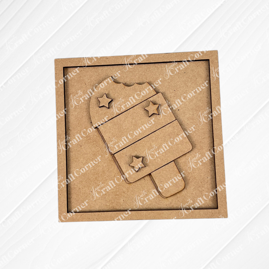 Janet's Craft Corner’s Patriotic Squares DIY craft kit features a square cardboard cutout with a popsicle shape, three stars, and two stripes in brown craft material—ideal for creating unique Independence Day home décor.