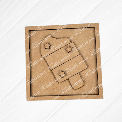Janet's Craft Corner’s Patriotic Squares DIY craft kit features a square cardboard cutout with a popsicle shape, three stars, and two stripes in brown craft material—ideal for creating unique Independence Day home décor.