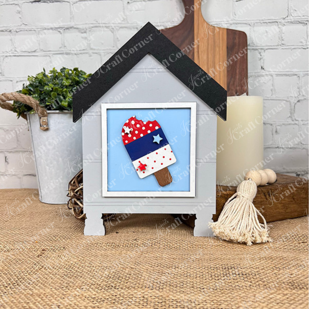 Janet's Craft Corner Patriotic Squares DIY seasonal home decor kit features patriotic popsicle art in a house-shaped white frame—ideal Independence Day décor or a festive craft activity for your celebration.