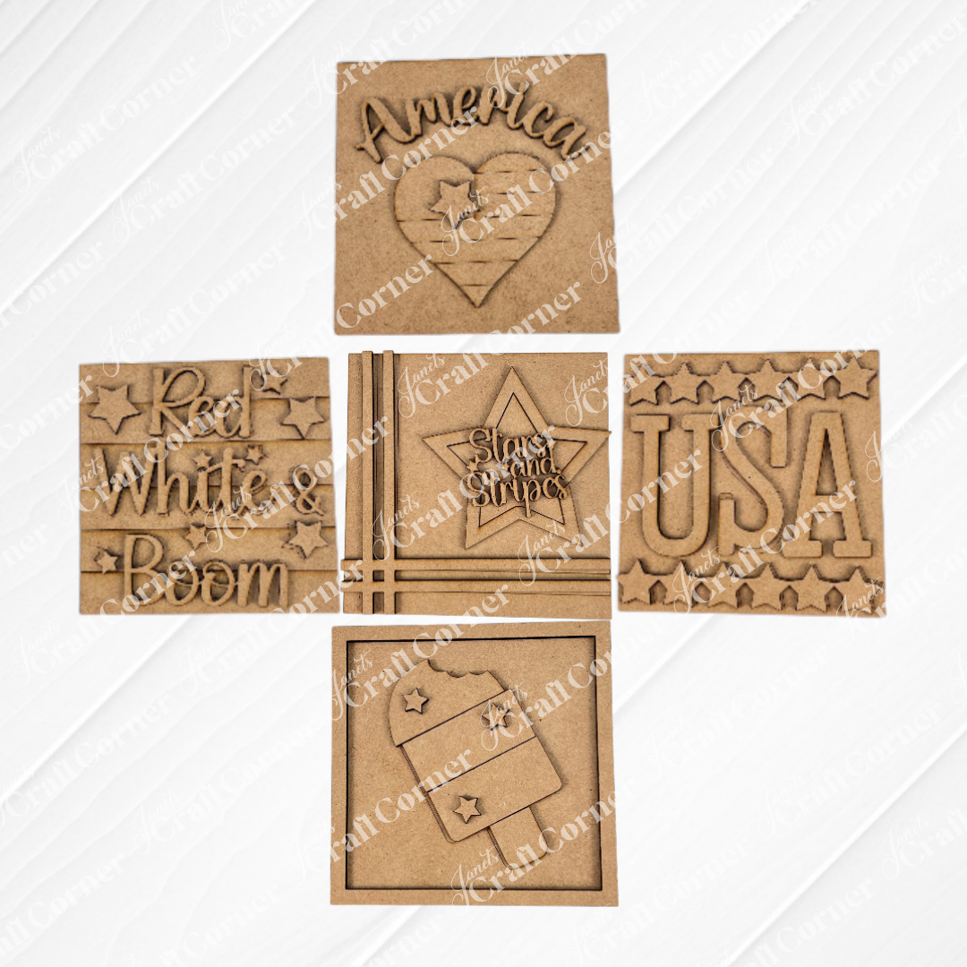 Janet's Craft Corner Patriotic Squares DIY kit includes five laser-cut wooden squares with “America,” “USA,” “Red White & Boom,” and flag motifs—perfect for creating unique Independence Day décor. Arranged in a grid on white.