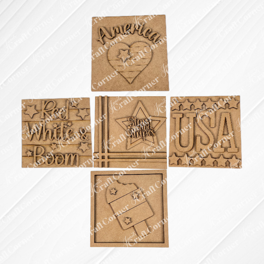 Janet's Craft Corner Patriotic Squares DIY kit includes five laser-cut wooden squares with “America,” “USA,” “Red White & Boom,” and flag motifs—perfect for creating unique Independence Day décor. Arranged in a grid on white.