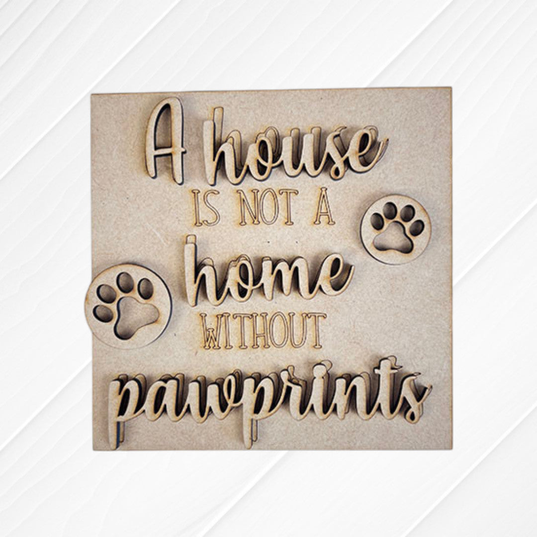 Janet's Craft Corner Dog Squares: Wooden sign featuring engraved and cut-out "A house is not a home without pawprints" text with two paw prints on light wood—ideal for tiered tray decor or pairing with other wood cut-outs.