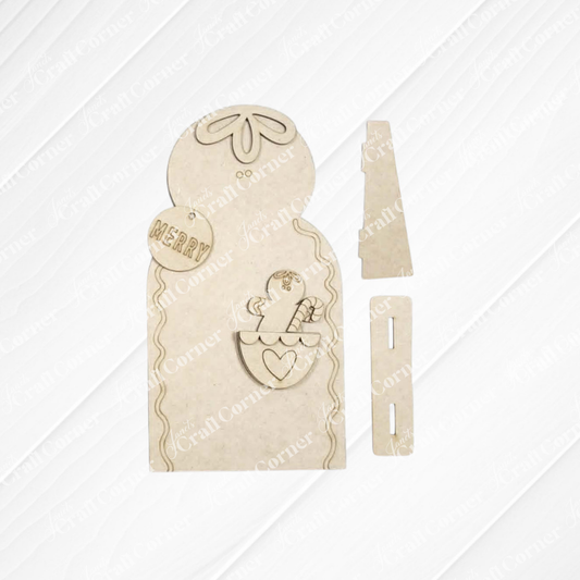 Introducing the Pocket Gingerbread Shelf Sitter DIY home decor craft kit from Janet’s Craft Corner—this unassembled set features charming wooden pieces, including a snowman with a hat, a “Merry” ornament, and a heart with holly. Designed for festive holiday decorating, each piece is slotted for easy assembly, making it perfect for creating your own delightful seasonal display. Set of 1.
