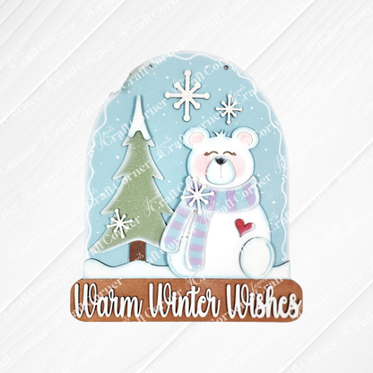 Janet's Craft Corner Polar Bear Door/Wall Hanger DIY kit features a snow globe-shaped decor with a white bear in scarf, pine tree, snowflakes, and “Warm Winter Wishes” on a light blue background. Perfect for seasonal home decorating. Set of 1.