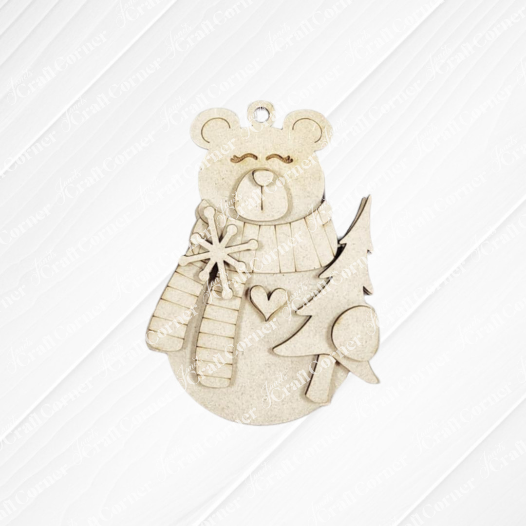 The Forest Friends Ornaments DIY craft kit by Janet's Craft Corner lets you make a wooden bear in a scarf holding a star by a tree, with a heart on its chest and hanging hole. Choose from 5 designs—perfect for animal ornament fans!.