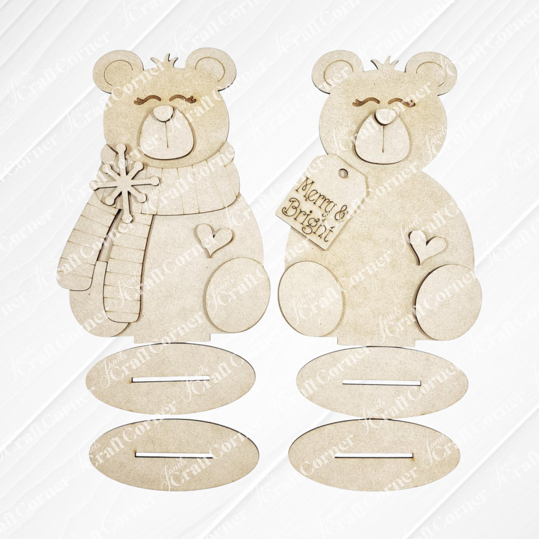 Janet's Craft Corner Polar Bear Shelf Sitters DIY kit includes your choice of two smiling polar bear figures—one with a scarf and snowflake, one with a “Merry & Bright” tag and heart—perfect for seasonal home decor.