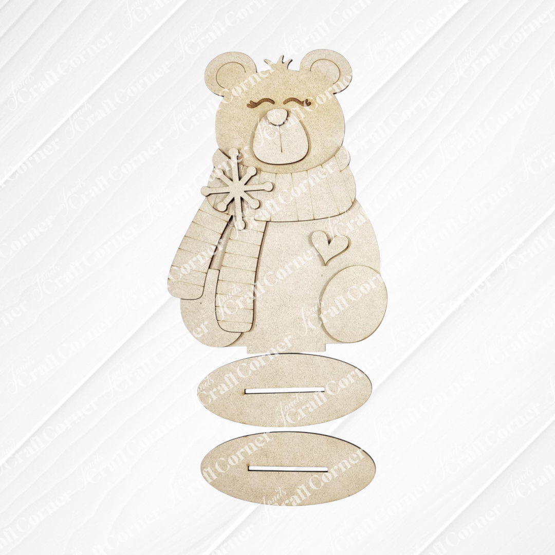 Create charming Polar Bear Shelf Sitters with Janet's Craft Corner DIY kit—features a wooden polar bear in scarf and mittens, holding a snowflake with a heart, and three oval slots. Choose from 2 seasonal designs for unique home decor.