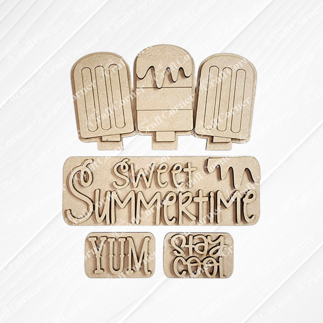 Wooden cutouts of three popsicles, decorated with phrases such as "Sweet Summertime," "Yum," and "Stay Cool" in fun, wavy fonts on a white background. This DIY home decor kit from Janet's Craft Corner is perfect for creating delightful decorations or an enchanting interchangeable insert.