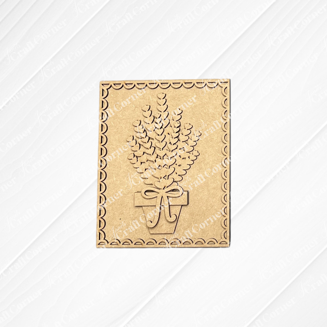 Janet’s Craft Corner’s Lavender Switchable Farmhouse Signs DIY kit features a potted plant cutout with a bow and scalloped edges on textured white—perfect small-space decor. Set of 1.