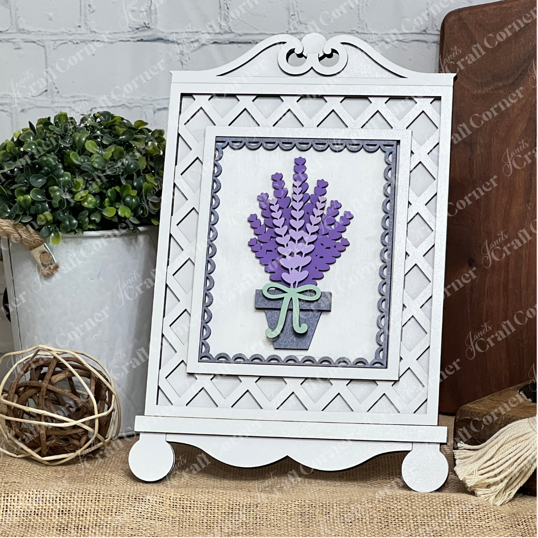 The Cottage Frame for Switchable Farmhouse Signs by Janet's Craft Corner is a DIY decor kit that beautifully displays interchangeable wall art, shown here with lavender art in a gray pot, styled on burlap with rustic accents.