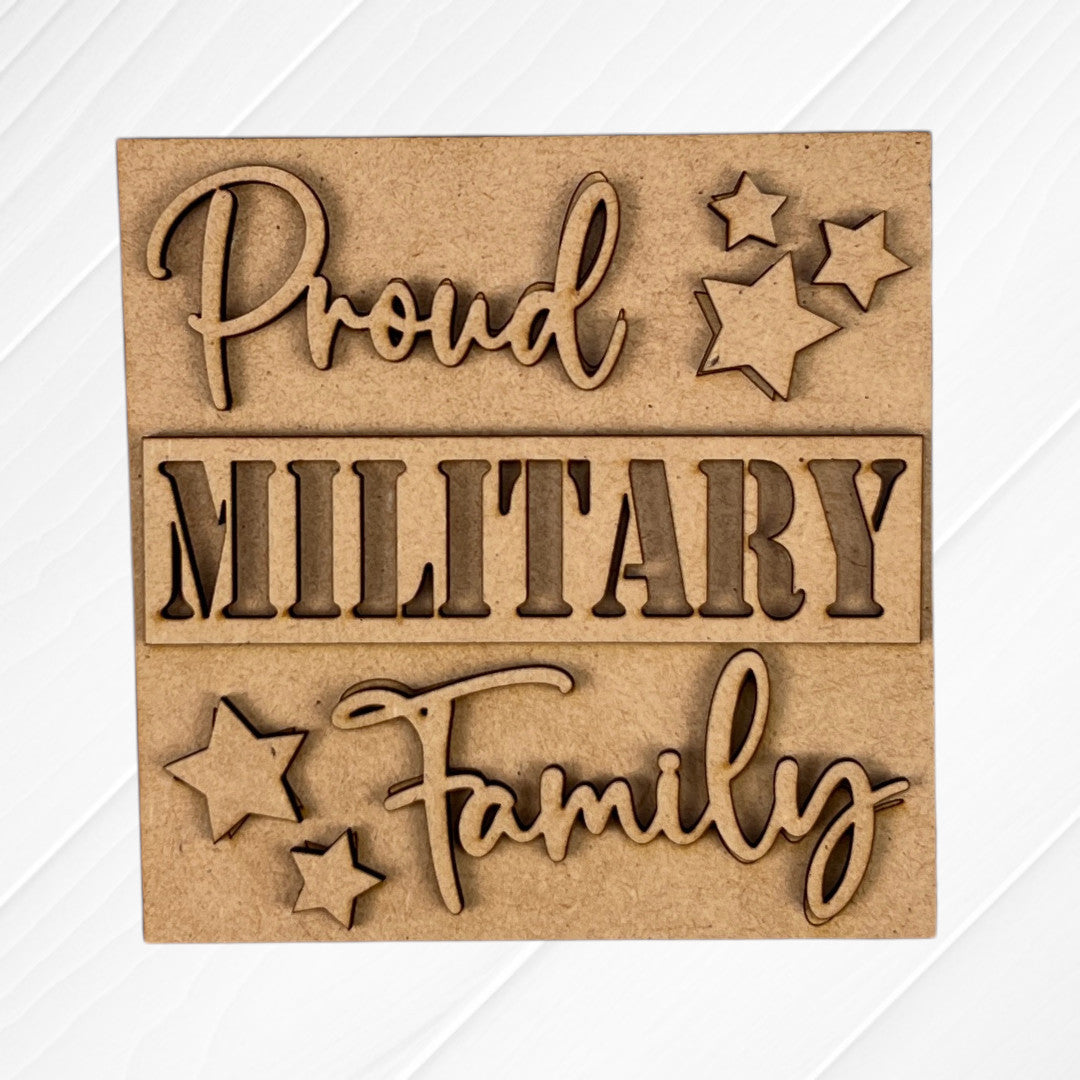 The Military Squares by Janet's Craft Corner feature "Proud MILITARY Family" in decorative script with star cut-outs, ideal for tiered tray decor, shown on a white textured background.