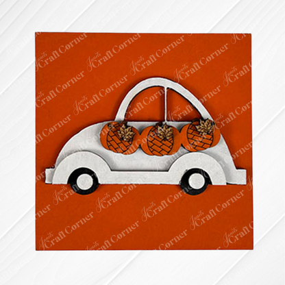 Pumpkin Spice Squares by Janet's Craft Corner features a white wooden car cutout carrying three orange pumpkins with brown stems and leaf details, all set on a solid orange background—perfect for tiered tray decor.
