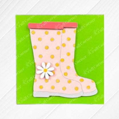 Hello Spring Squares by Janet's Craft Corner: Pink rain boots with yellow polka dots, white soles, red trim, and a daisy—perfect for tiered tray decor or playful wood cut-outs—set on green with a diagonal striped white border.