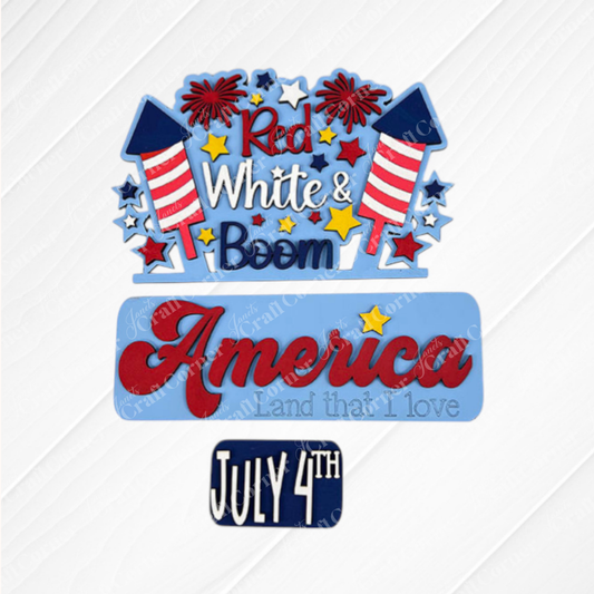 The Red White & Boom Interchangeable Insert - Painted by Janet's Craft Corner features colorful fireworks and stars, celebrating American Pride with the text "Red, White & Boom" at the top, "America, Land that I love" in the middle, and "July 4th" at the bottom. This decorative piece is perfect for enhancing your home decor with its textured background flair.