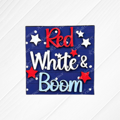 A blue sign reads "Red White & Boom" in red, white, and blue letters with stars—perfect for Independence Day or as inspiration for Janet's Craft Corner’s Patriotic Squares DIY seasonal home decor craft kit.