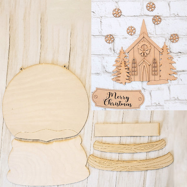 On a light wooden surface, the Rustic Church Snow Globe Sign DIY Decor Kit from Janet's Craft Corner is ready for assembly and decoration. This kit includes blank wooden shapes like a church with trees, snowflakes, and a "Merry Christmas" sign—ideal for creating charming home décor with a personal touch.