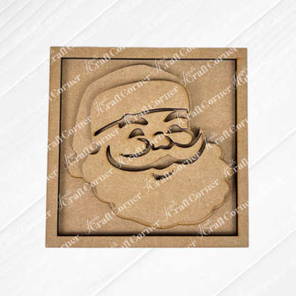 Santa Squares by Janet's Craft Corner: a laser-cut wooden ornament with a smiling Santa face in a square frame—ideal for DIY holiday decor or adding to your Swappable Squares kit. Shown on a diagonal textured white background.