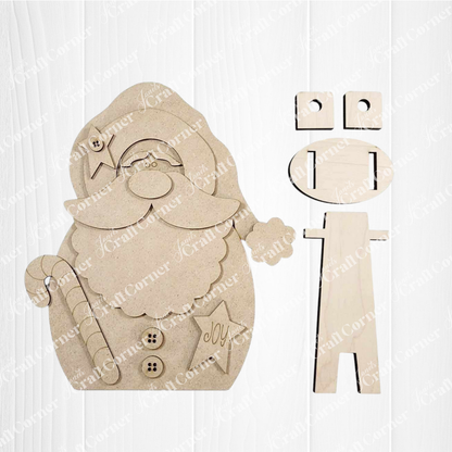 Janet's Craft Corner Santa Shelf Sitter DIY kit includes unpainted wooden Santa, candy cane, star, and assembly pieces—ideal for festive holiday decor or as a charming shelf sitter. Set of 1; displayed on a white wooden background.