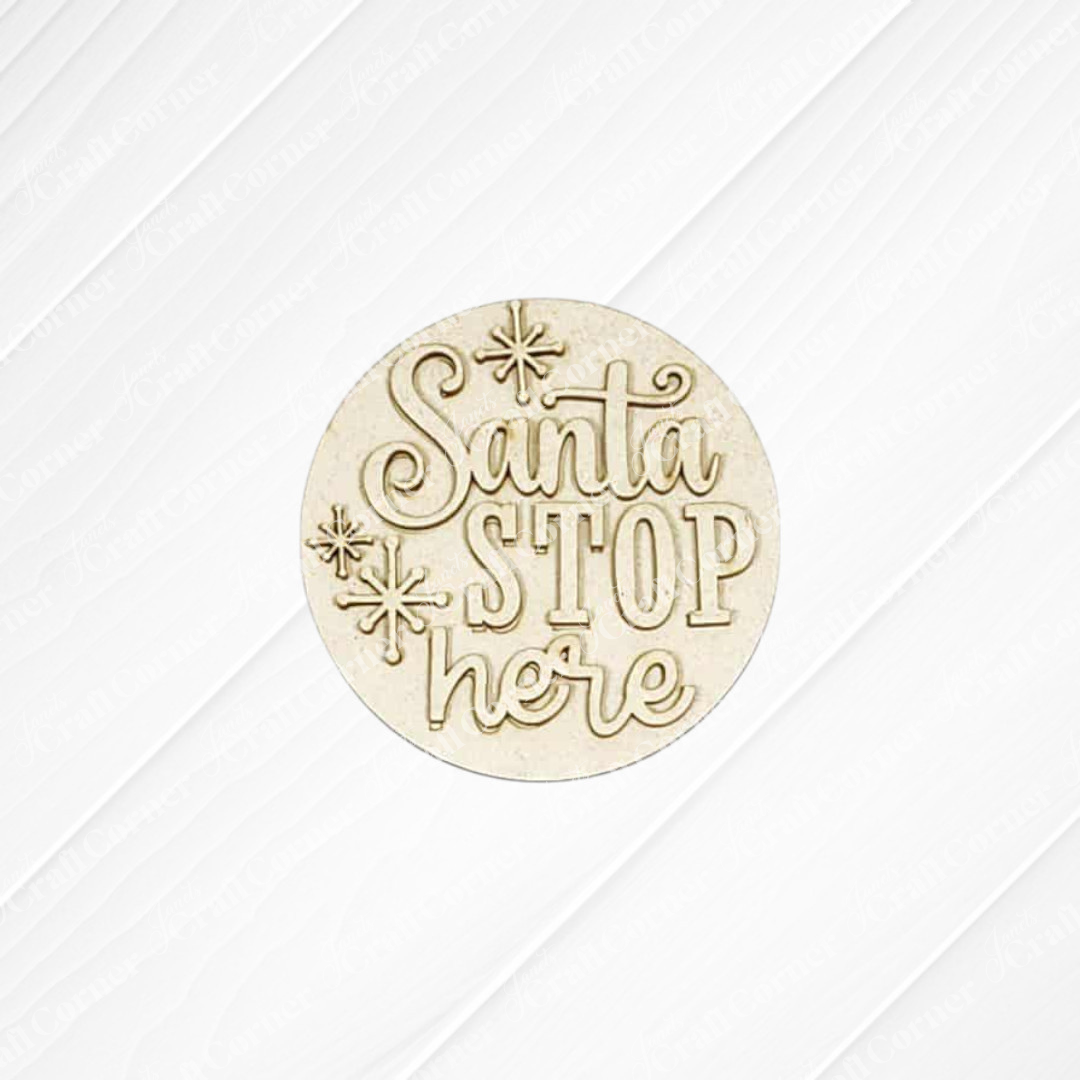 The North Pole Decor Set by Janet's Craft Corner features a round wooden ornament engraved with "Santa Stop Here" and star accents, perfect for holiday decor. Shown on a white textured background.