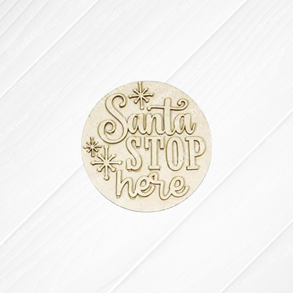 The North Pole Decor Set by Janet's Craft Corner features a round wooden ornament engraved with "Santa Stop Here" and star accents, perfect for holiday decor. Shown on a white textured background.