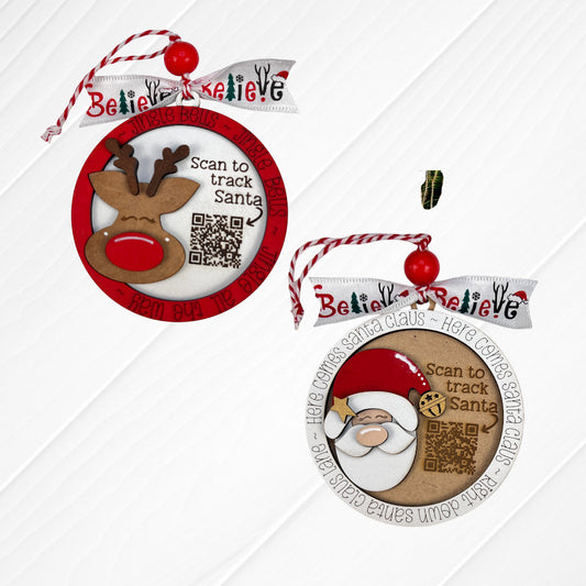 Heartland Santa Tracker Ornaments – Choice of 2 – Painted: Add a whimsical touch to your holiday décor with these two charming round ornaments, each featuring a festive QR code. One ornament showcases a reindeer and ribbon that reads “Believe,” while the other displays Santa Claus with a ribbon that says “Here comes Santa Claus.” Both ornaments are adorned with red beads and striped twine hangers, making them delightful accents for farmhouse-style Christmas decorating or as playful additions to your tree.