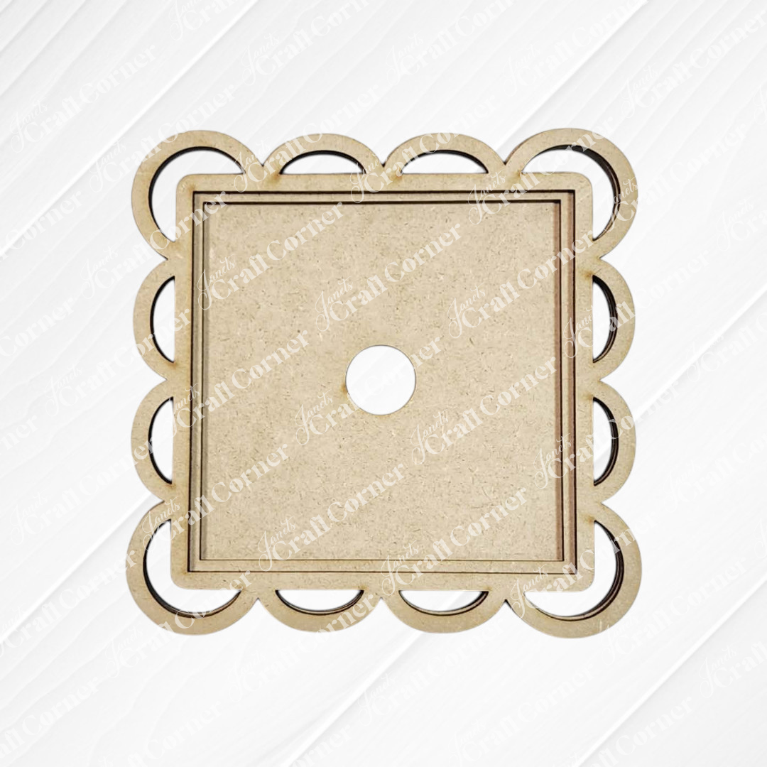 The Scallop Lace Square Frame by Janet's Craft Corner is an unfinished wooden board with a scalloped edge and central hole, perfect for DIY seasonal decor, shown on a white textured background.