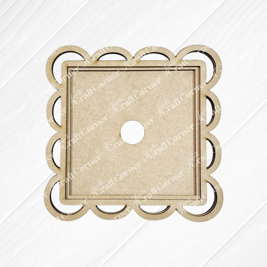 The Scallop Lace Square Frame by Janet's Craft Corner is an unfinished wooden board with a scalloped edge and central hole, perfect for DIY seasonal decor, shown on a white textured background.