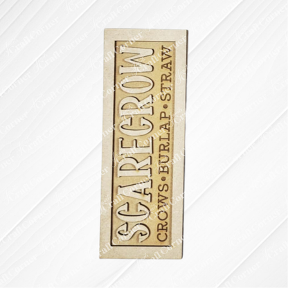 Janet's Craft Corner Fall Scarecrow Mini Shelf Sitters DIY kit includes a beige, rectangular sign with “SCARECROW” and “CROWS • BURLAP • STRAW”—ideal for adding charm to your seasonal home decor projects. Set of 1.