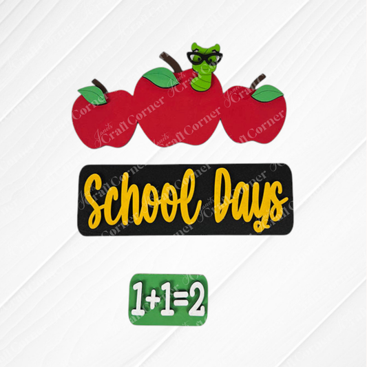 The School Days Interchangeable Insert by Janet's Craft Corner showcases a farmhouse decor sign featuring three apples, one with a quirky green worm wearing glasses. The phrase "School Days" is prominently displayed in yellow against a black background, with "1+1=2" underneath. This piece serves as an ideal addition for interchangeable craft inserts or to enhance your DIY craft kit projects, set against a textured white pattern backdrop.