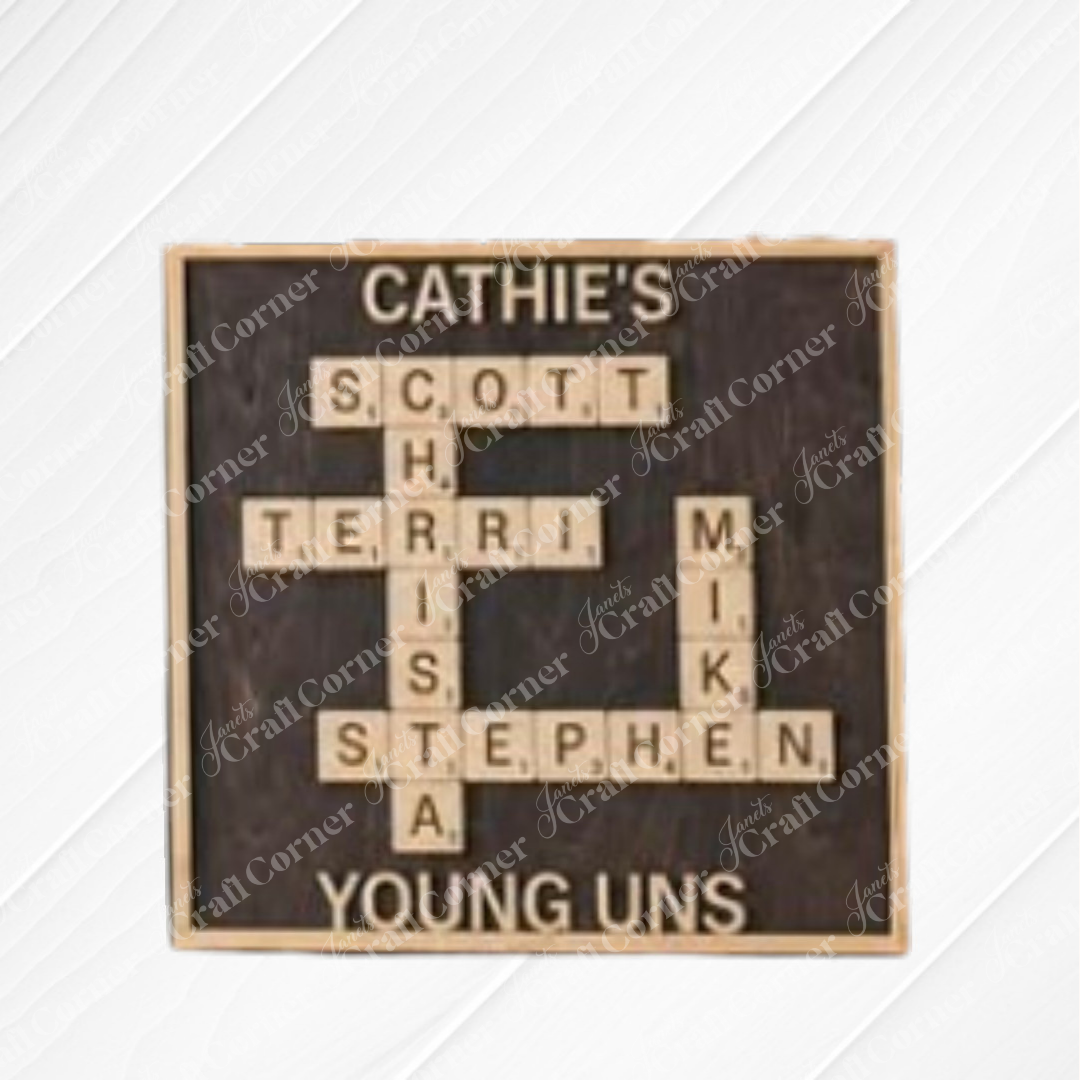 The Scrabble Board Sign from Janet’s Craft Corner displays names like Scott, Terri, Christa, Stephen, and Mike crossword-style on a dark background—perfect as a custom teacher gift.
