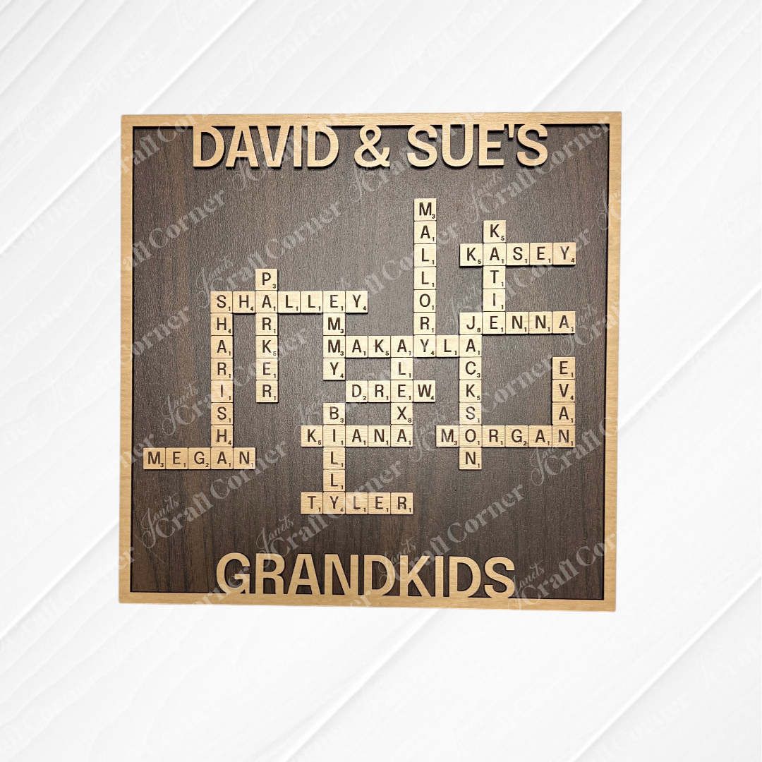 The Scrabble Board Sign by Janet's Craft Corner is a custom wooden wall art with Scrabble tiles that spell grandchildren’s names under "David & Sue’s," with "Grandkids" below—an ideal personalized family decor or teacher gift.