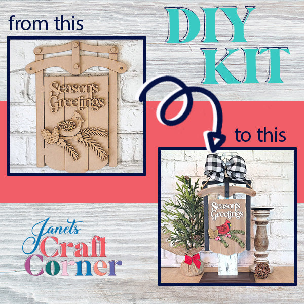 The Season's Greetings Sled Door Hanger DIY kit from Janet's Craft Corner transforms an unfinished wooden sled door hanger featuring the message "Season's Greetings" with pinecones and leaves into a festive holiday decor piece. The completed project is adorned with embellishments such as a bow, greenery, and a candle stand.