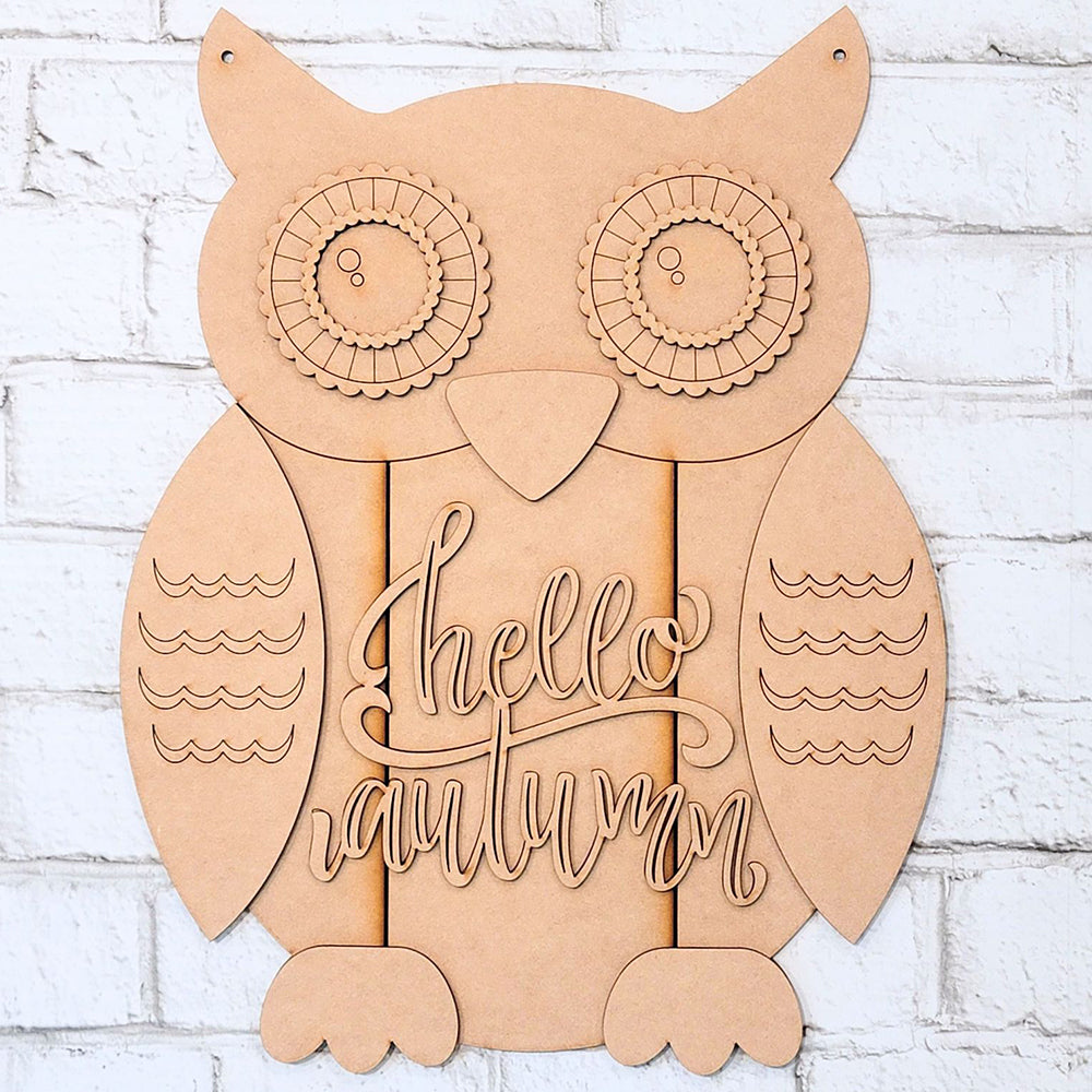 The Shiplap Owl Door Hanger DIY home decor kit from Janet's Craft Corner is a delightful project featuring detailed designs on the owl's eyes and wings. The center of the hanger displays the message "hello autumn," beautifully contrasted against a white brick background.