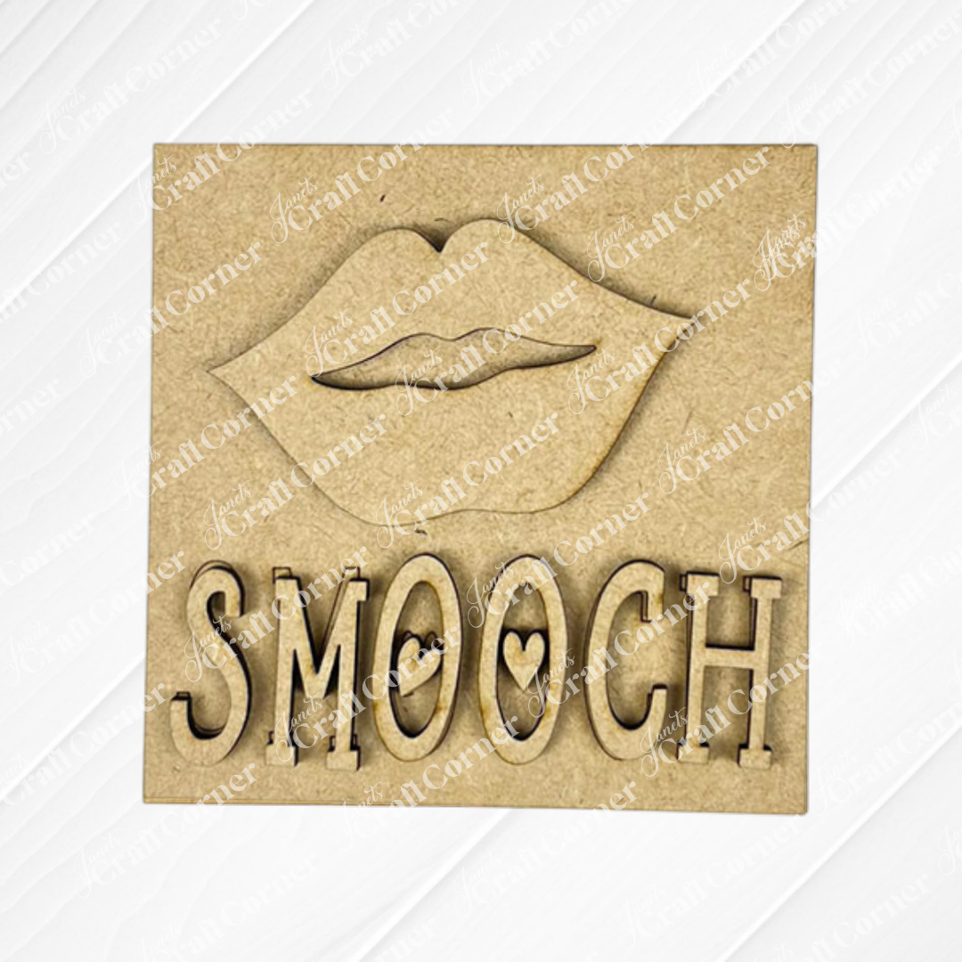 The Love Squares plaque by Janet's Craft Corner features a bold lips outline above "SMOOCH" with a heart in the "O," making it a charming wooden accent for tiered trays or seasonal home decor.