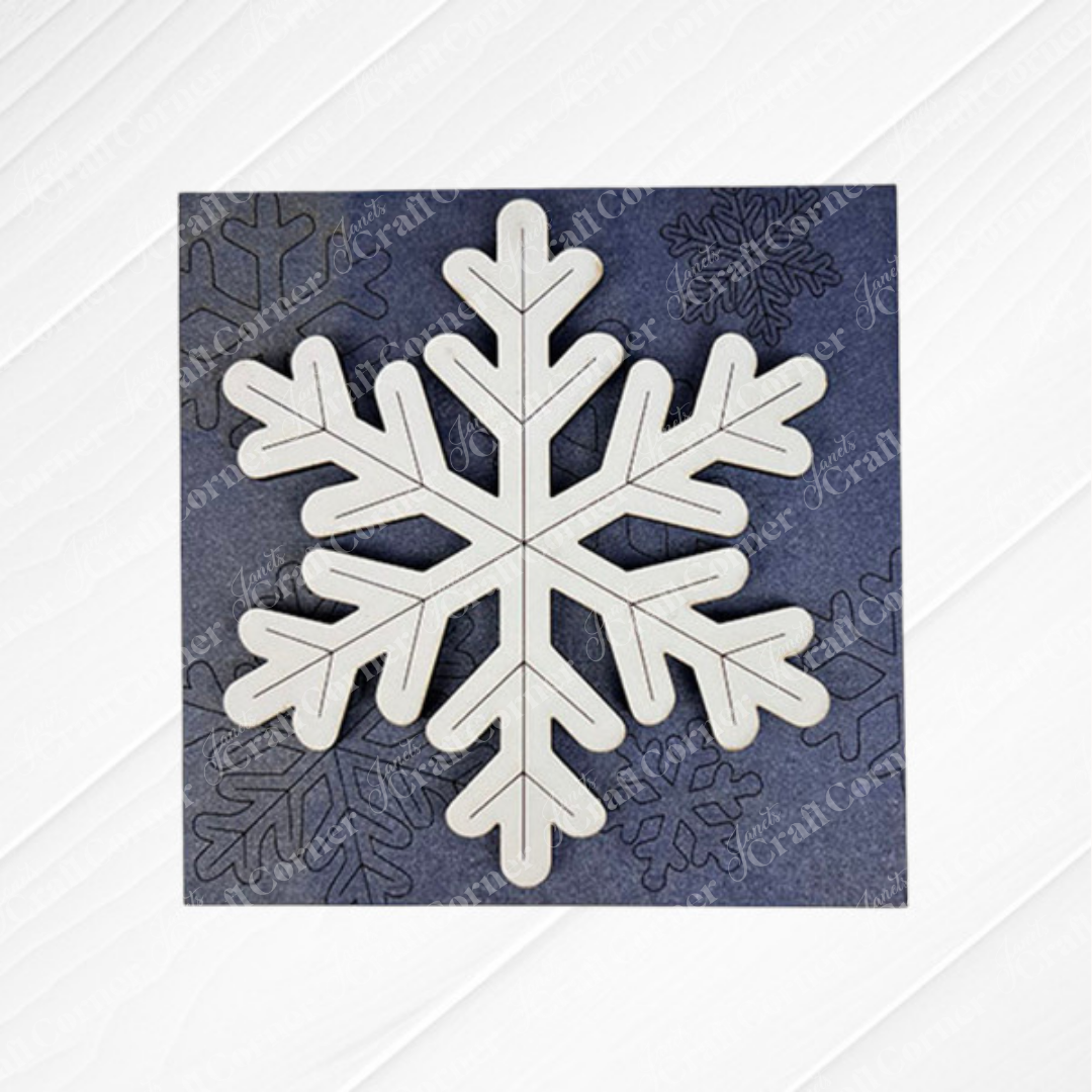 A white, six-pointed snowflake cut-out from Janet's Craft Corner's Snow Squares is centered on a dark textured background with subtle snowflake outlines—ideal for DIY seasonal decor or use in Swappable Square Displays.