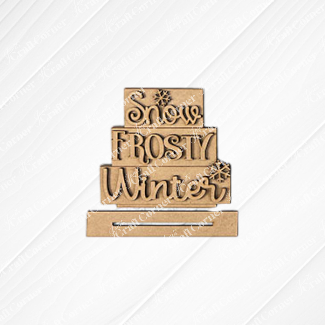 Create a festive atmosphere with the Snow-Frosty-Winter Word Stack from Janet's Craft Corner. This winter-themed display is shown on a white shiplap background. Use the DIY kit to add an enchanting touch to your winter décor.