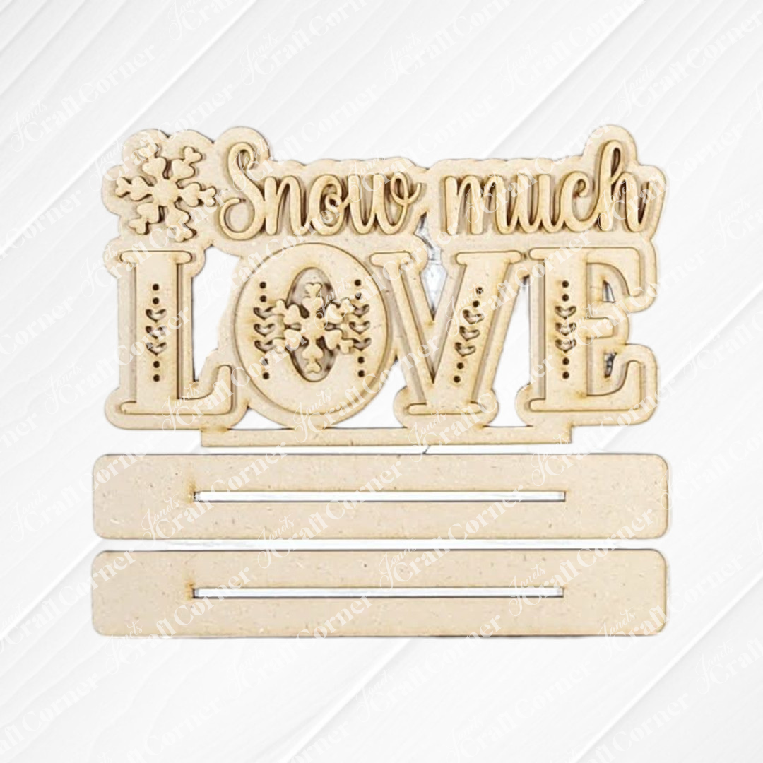 Janet's Craft Corner’s Valentine Snowmen Decor Set features a wooden sign with “Snow much LOVE,” snowflake designs, and two customizable slots—ideal to pair with your favorite DIY craft kit or wood cut-outs.