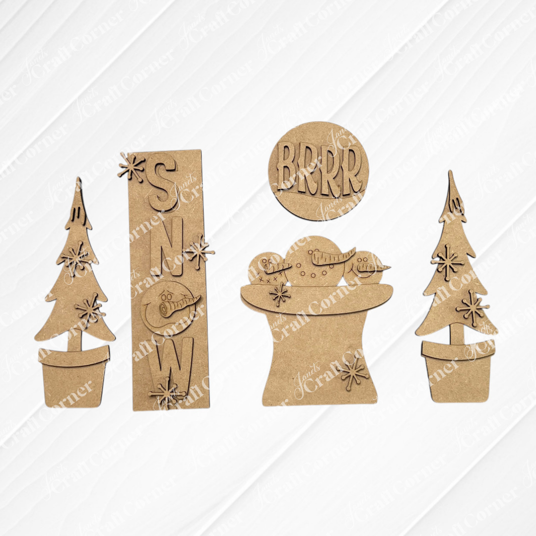 The Snow Interchangeable Porch Set by Janet's Craft Corner includes five laser-cut wood winter shapes: two potted pines, a “SNW” sign, “BRRR” circle, and mitten with scarf—ideal for DIY seasonal decor or interchangeable displays.