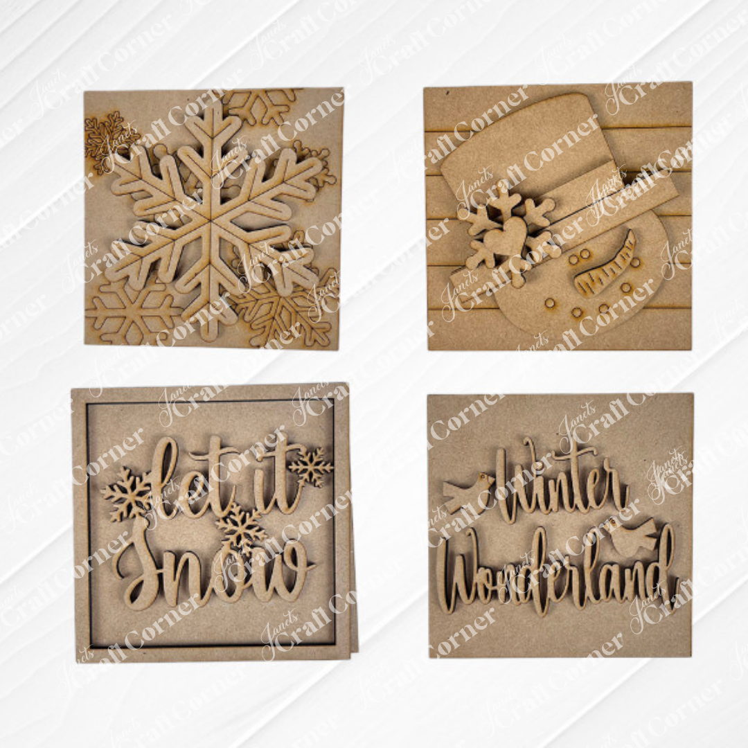 Snow Squares by Janet’s Craft Corner: four square, brown, laser-cut ornaments—snowflake, snowman parts, “let it snow,” and “Winter Wonderland” with birds—are a perfect DIY seasonal home decor craft kit with a wood-textured finish.