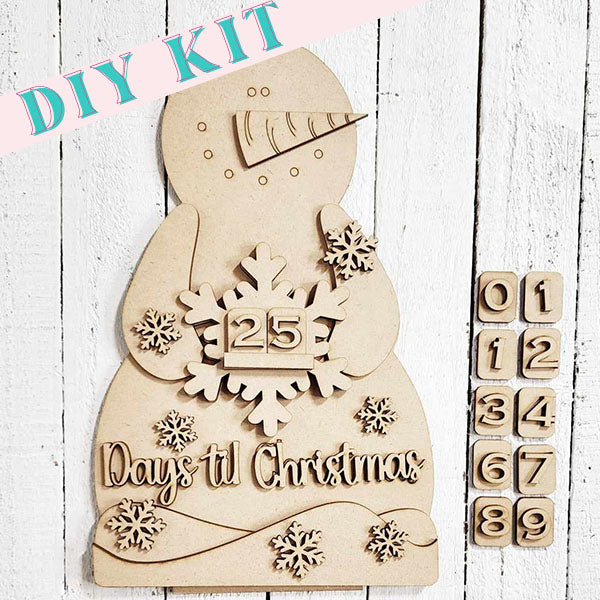 Janet's Craft Corner presents the Snowman Countdown Shelf Sitter DIY Kit, a delightful addition to your holiday home décor. This wooden snowman features a snowflake with the number 25 and comes with slots for arranging tiles numbered 0-9, allowing you to easily count down the days until Christmas.