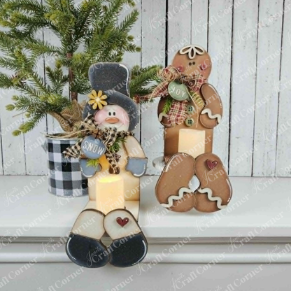 Add a cheerful holiday accent to your space with the Snowman & Gingerbread Votive Holder Shelf Sitters DIY home decor craft kit by Janet’s Craft Corner. Displayed on a white shelf, these festive figures—adorned with winter accessories—are paired with a small potted pine tree in a black-and-white plaid pot. The charming arrangement of this craft kit brings inviting Christmas home decor and cozy seasonal spirit to your room.