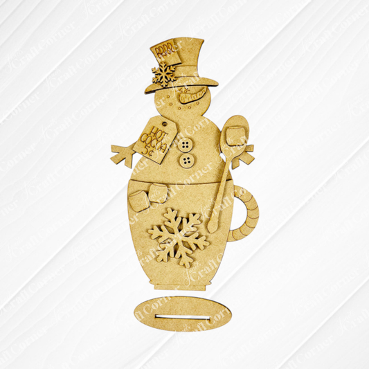 This DIY kit from Janet's Craft Corner includes a Snowman Hot Cocoa Mug Shelf Sitter featuring a snowman in a top hat, with button and snowflake details, holding a spoon and "Hot Cocoa 5¢" sign for unique seasonal home décor.