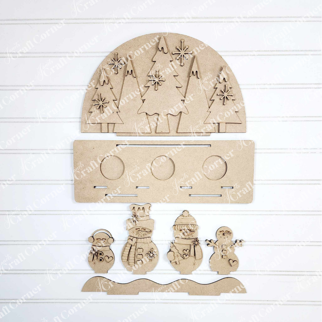 Create a charming winter scene with Janet's Craft Corner Snowman Tealight Shelf Sitter DIY kit, featuring laser-cut wooden shapes—a half-circle with trees, snowflakes, five snowmen, and a base—perfect for seasonal home decor.