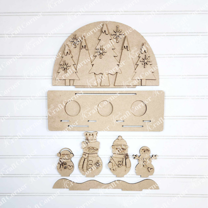 Create a charming winter scene with Janet's Craft Corner Snowman Tealight Shelf Sitter DIY kit, featuring laser-cut wooden shapes—a half-circle with trees, snowflakes, five snowmen, and a base—perfect for seasonal home decor.