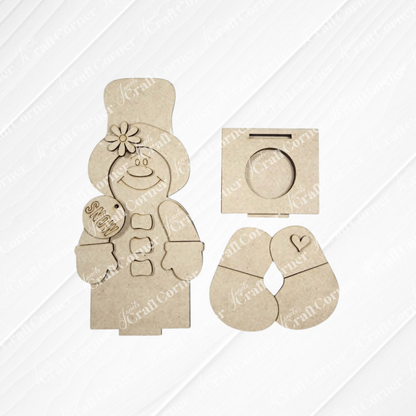 Janet’s Craft Corner Snowman & Gingerbread Votive Holder Shelf Sitter DIY home decor craft kit includes laser-cut MDF pieces to create a charming snowman holding a sign, with separate sections for the head, arms, and body displayed on a white wood background—perfect for unique Christmas home decor or as a festive votive holder shelf sitter.