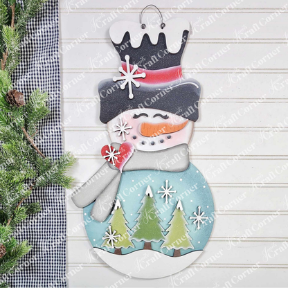 Display cheerful holiday spirit with Janet's Craft Corner Snowman Trees Wall/Door Hanger DIY kit—this festive set of 1 features a snowman with black hat, scarf, heart, and 3 green trees for your wall or door decor.
