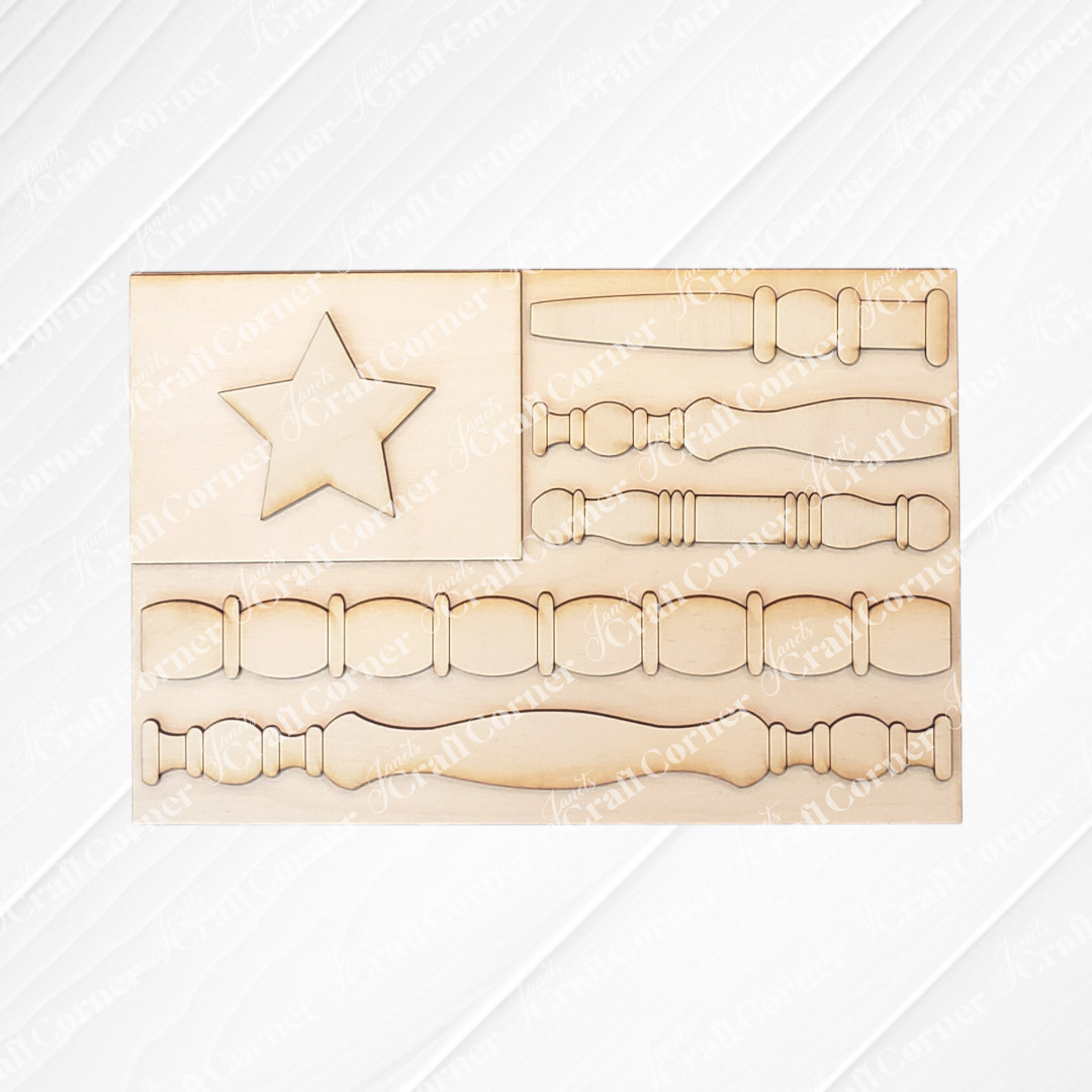 The Spindle Flag Shelf Leaner – DIY Craft Kit by Janet's Craft Corner features an American flag cutout with a star and spindle-shaped stripes—perfect for patriotic décor or customizing as a farmhouse shelf accent.