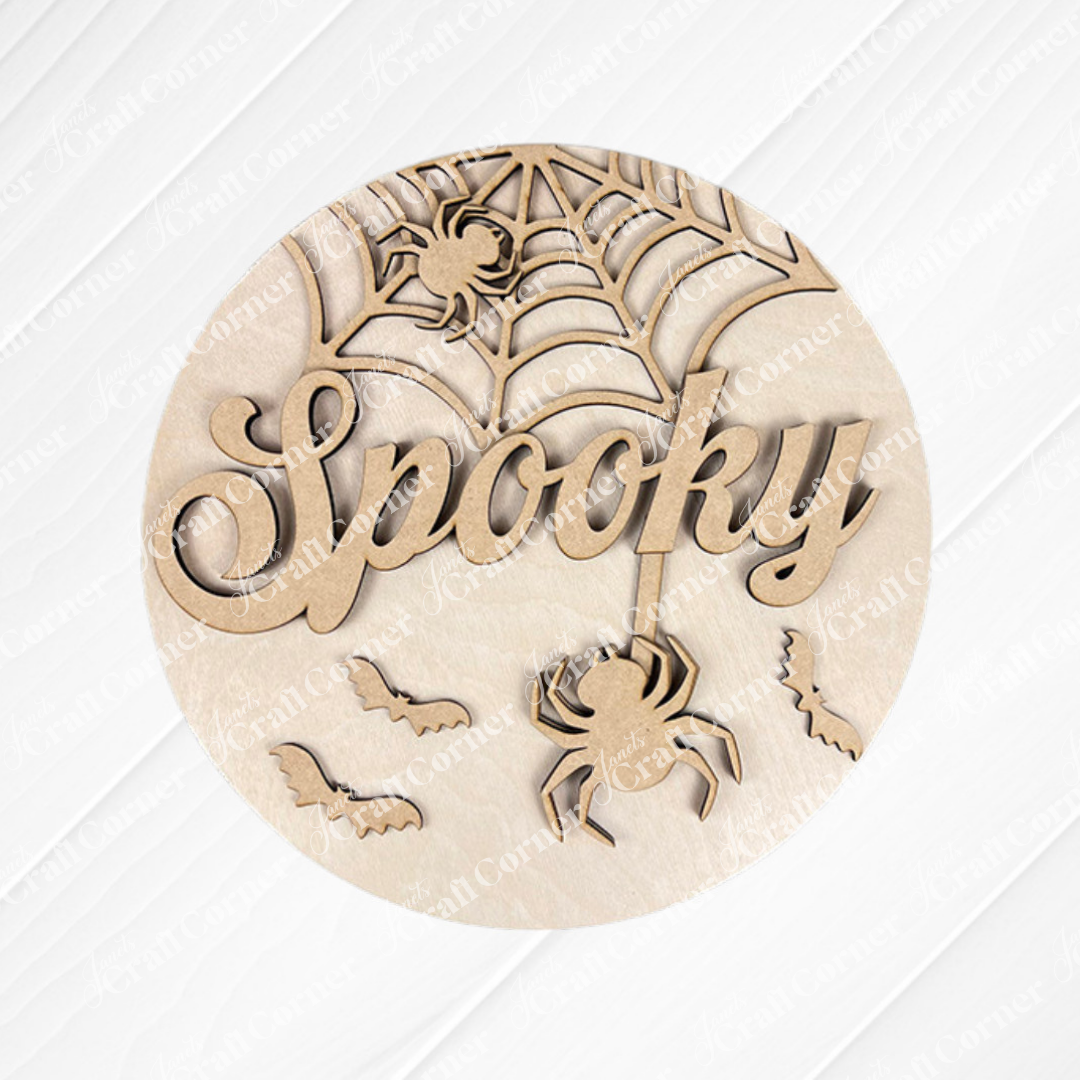 Add a festive touch to your home with the “Spooky Halloween Wall Hanger” from Janet’s Craft Corner. This DIY seasonal home decor craft kit features a wooden round sign intricately carved with the word “Spooky,” a spider dangling from a web, another spider perched on the web, and three flying bats—all in a Halloween theme.